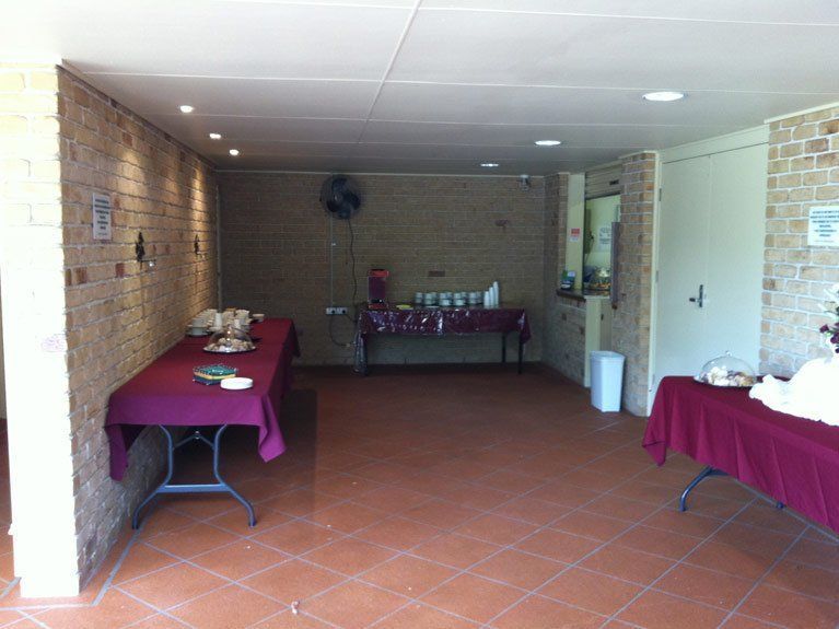 A room with tables and a brick wall