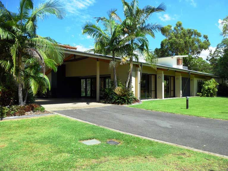 A large house with palm trees in front of it