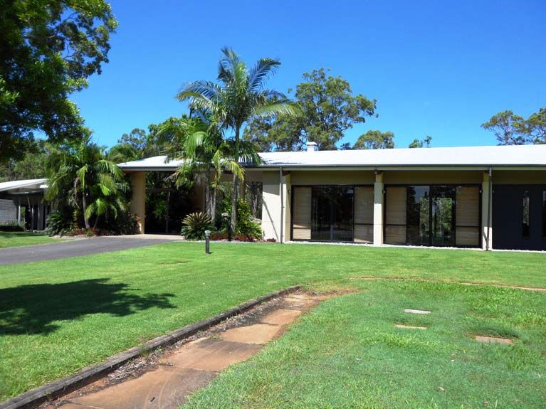 A large house with a lush green lawn in front of it