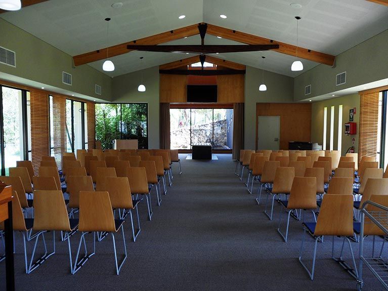 Rows of chairs are lined up in a large room