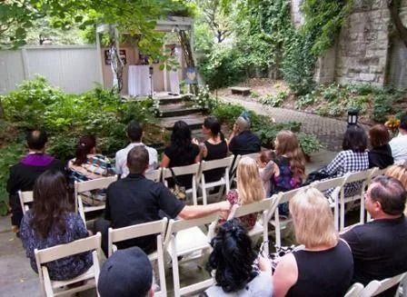 A group of people are sitting in chairs watching a wedding ceremony.