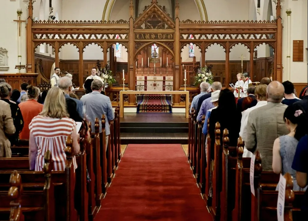 A large group of people are sitting in a church.