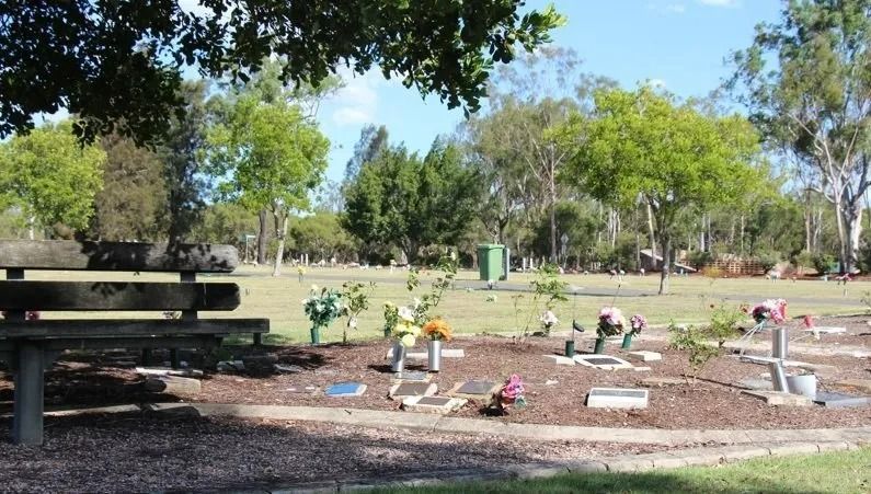 A cemetery with a bench in the foreground