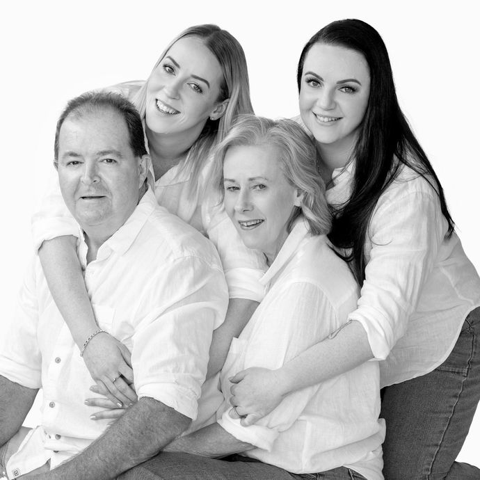 A black and white photo of a family posing for a picture