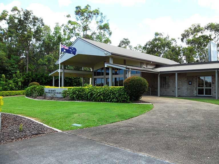 A large building with a flag flying in front of it