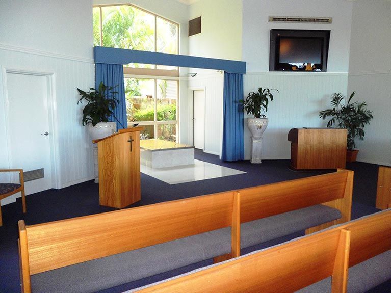 A church with a podium and a television on the wall