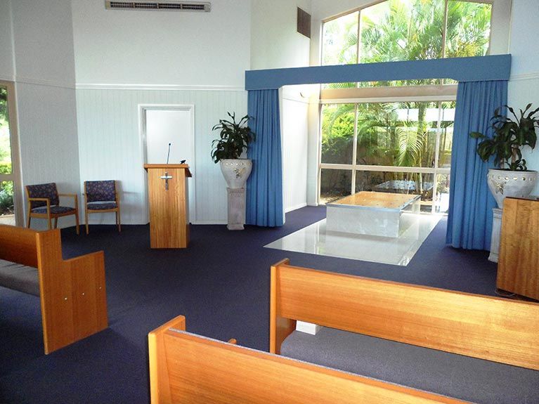 A church with wooden benches and a podium