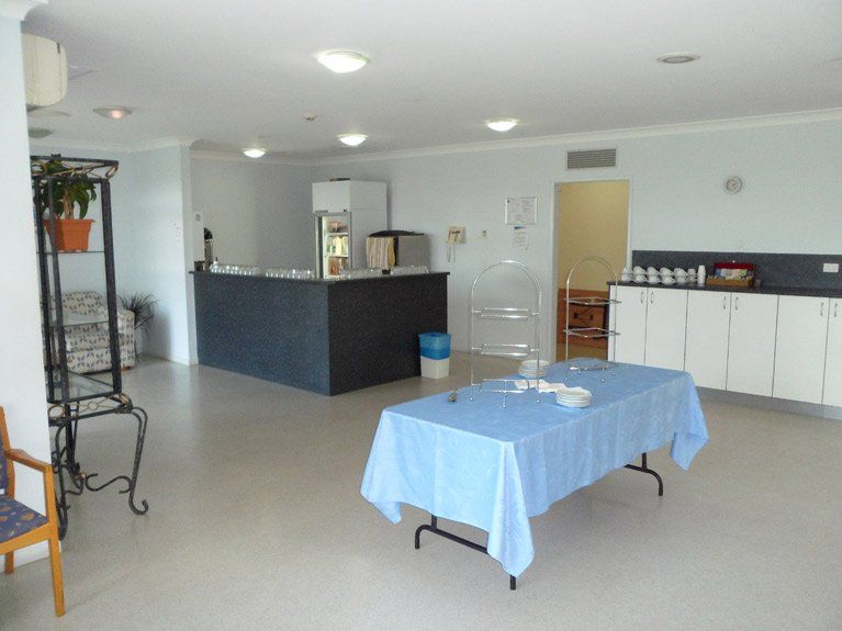 A table with a blue table cloth in a room