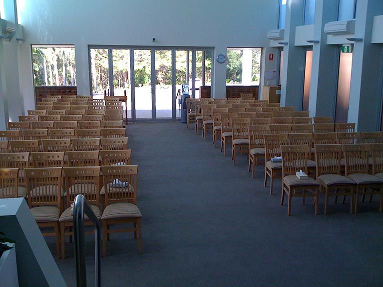 Rows of wooden chairs in an empty church