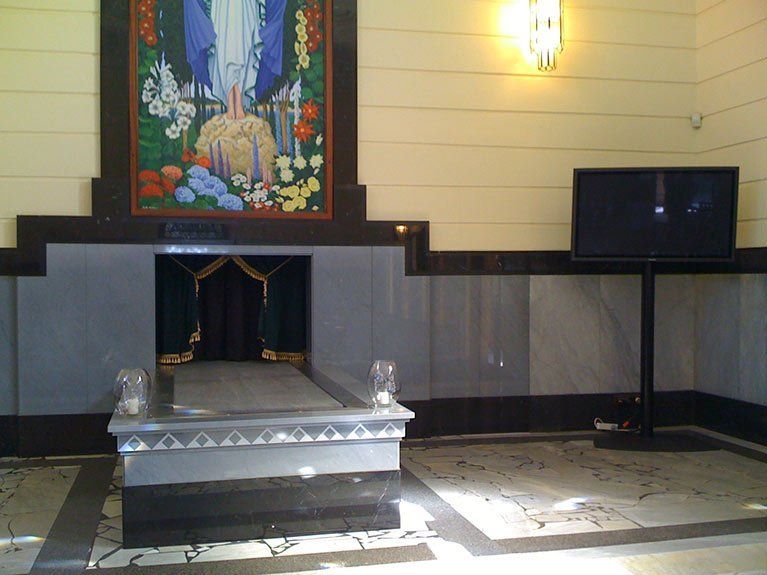 A room with a fireplace and a television on a stand