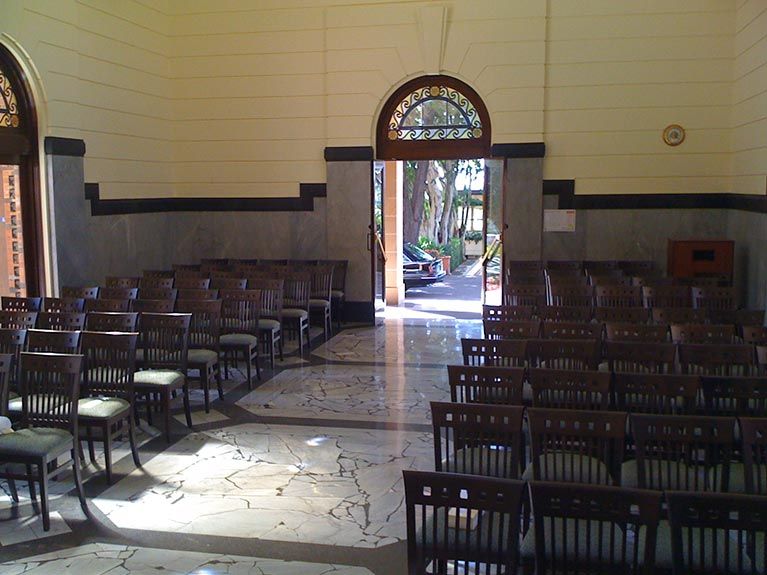 A room with rows of chairs and a door that is open