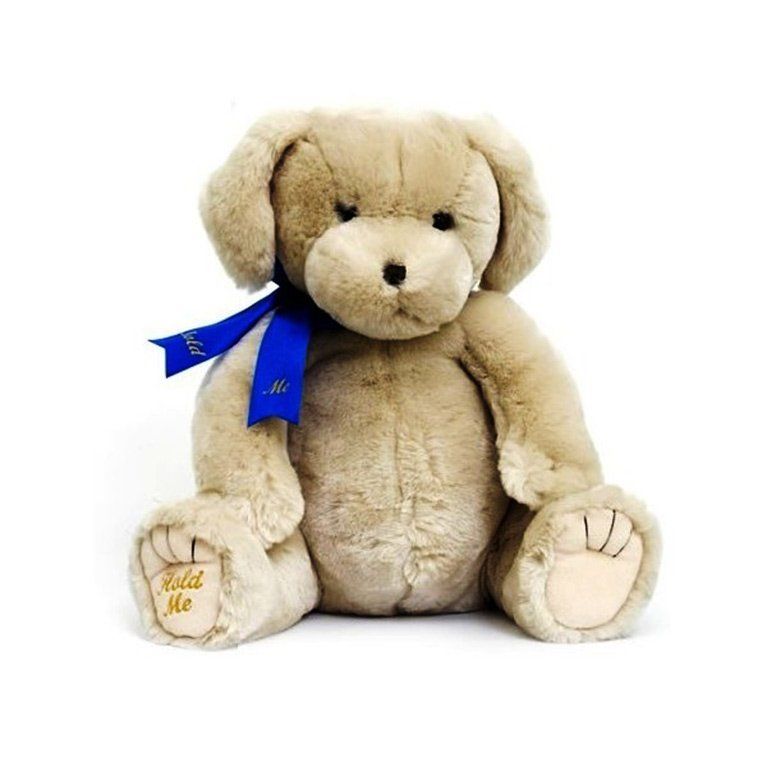 A brown teddy bear with a blue ribbon around its neck