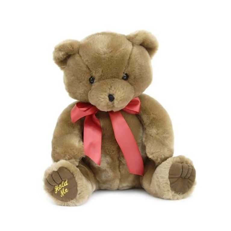 A brown teddy bear with a red ribbon around its neck