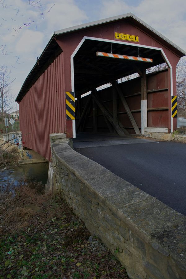 A red covered bridge with the word ready on the top