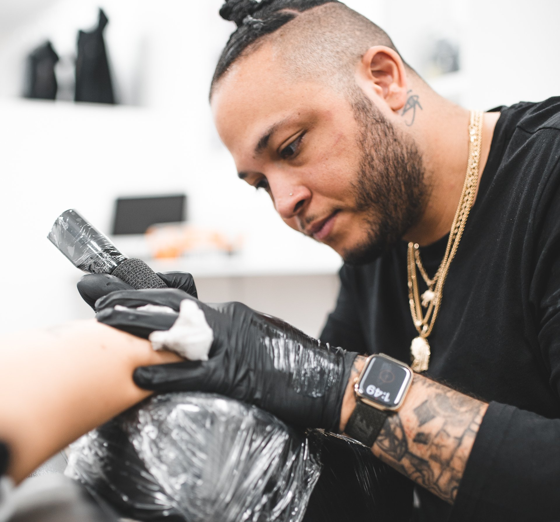 Close up shot of Chris Redmon giving a tattoo to a client