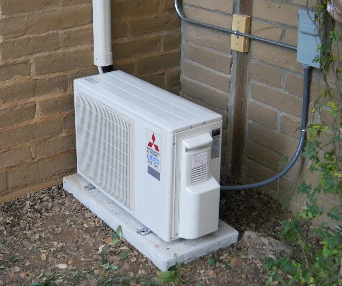 A man is using a cell phone while working on a machine in Fort Lauderdale FL