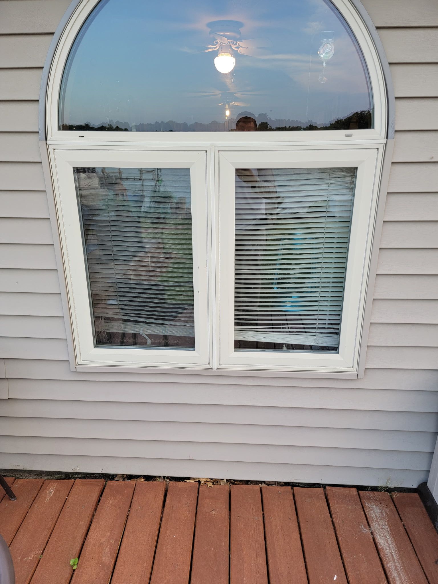 Interior construction: Drywall installed around window, unfinished, purple drywall visible.