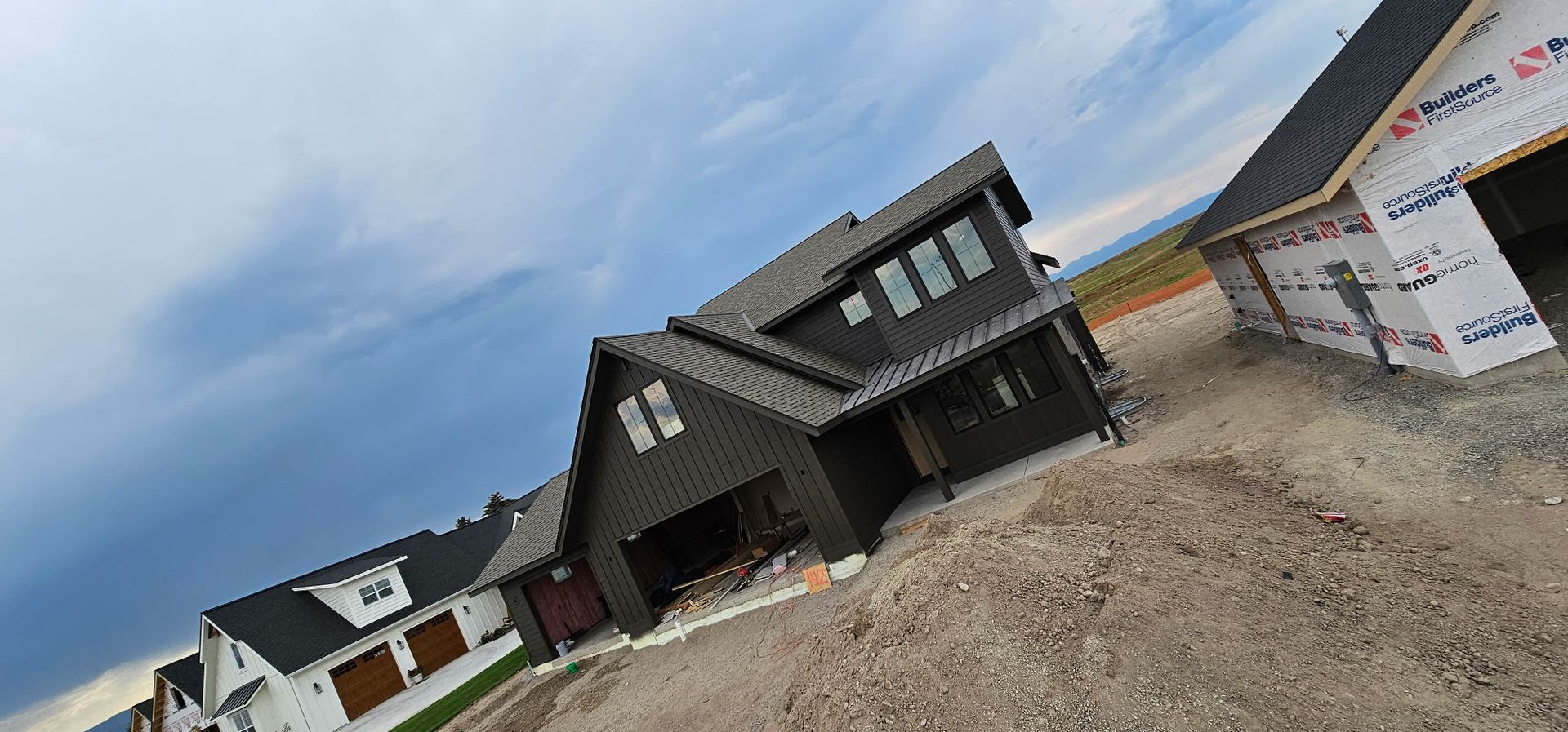 Person in hoodie building wooden frame inside warehouse.