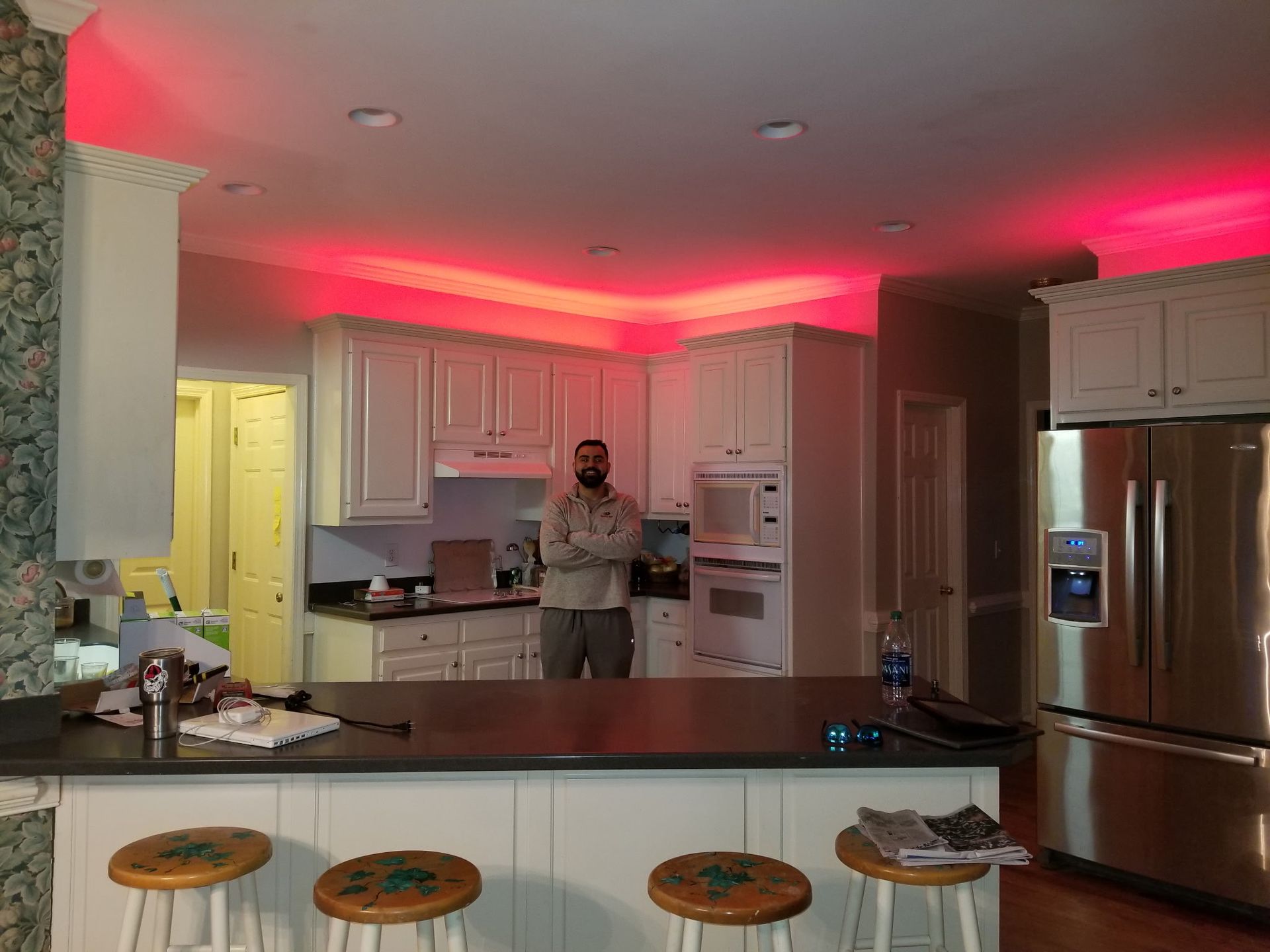 Interior wall damage after renovation, showing exposed studs, wiring, and plumbing.
