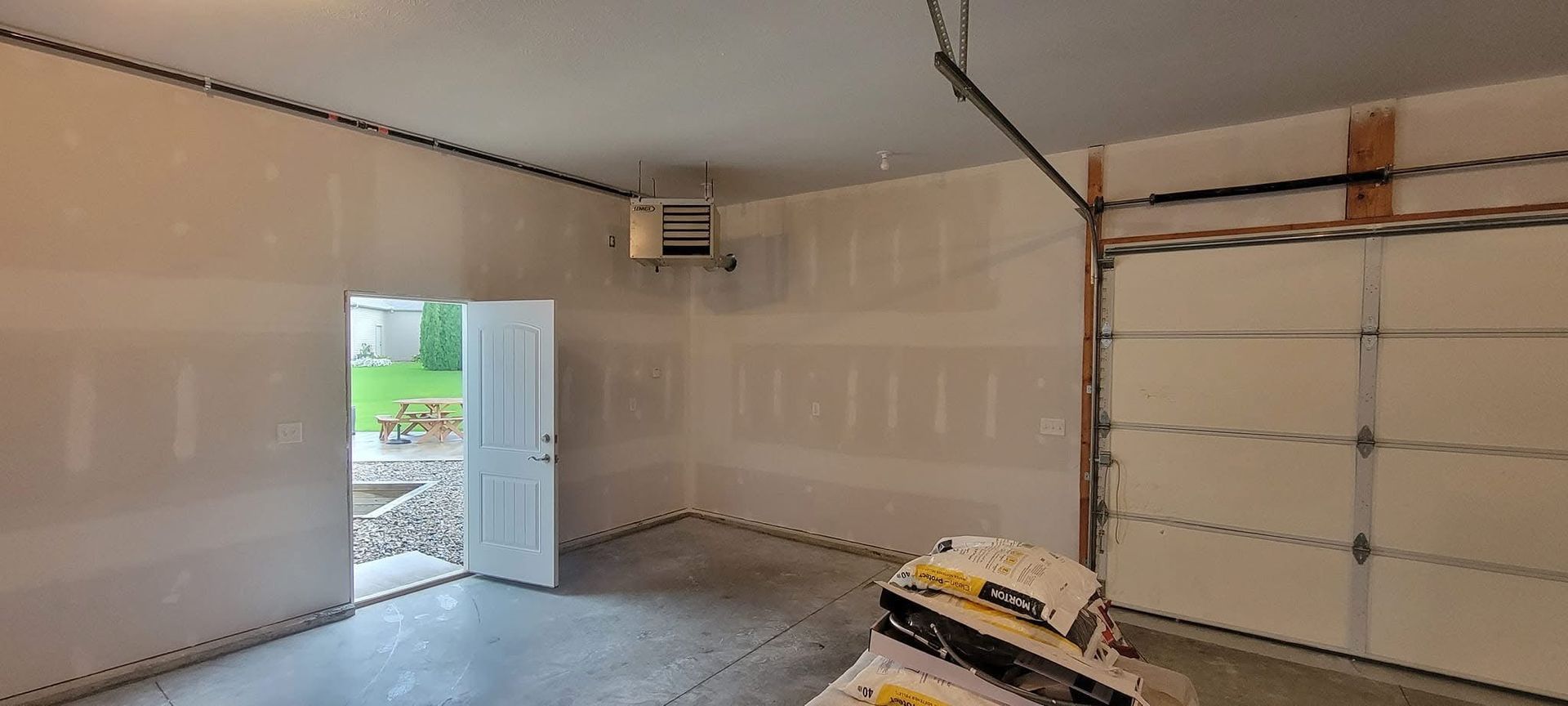 Man using a power drill to install a smart lock on a brown door.