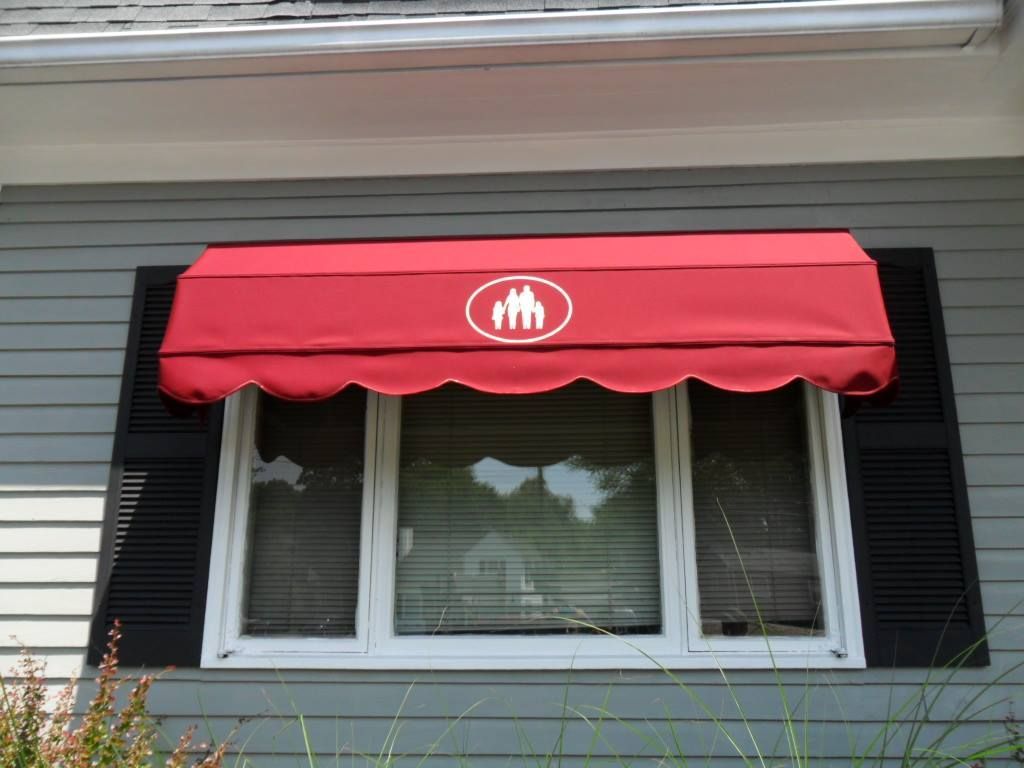 A window with a red awning over it