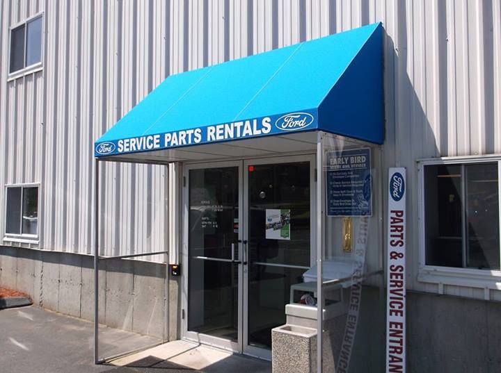 A blue awning over the entrance to a ford service parts rental