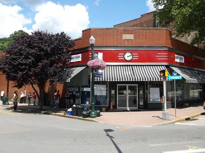 A red building with a clock on the top of it