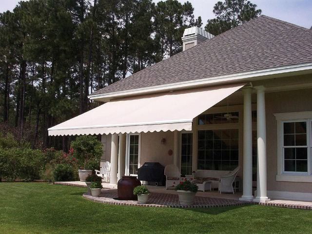 A house with a white awning on the porch