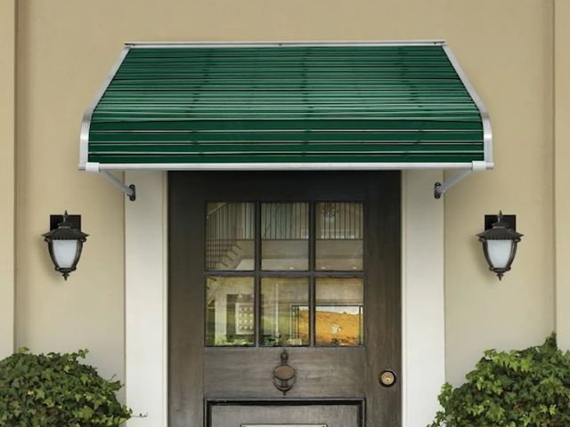 A gray building with red and white awnings and a sign that says gww properties