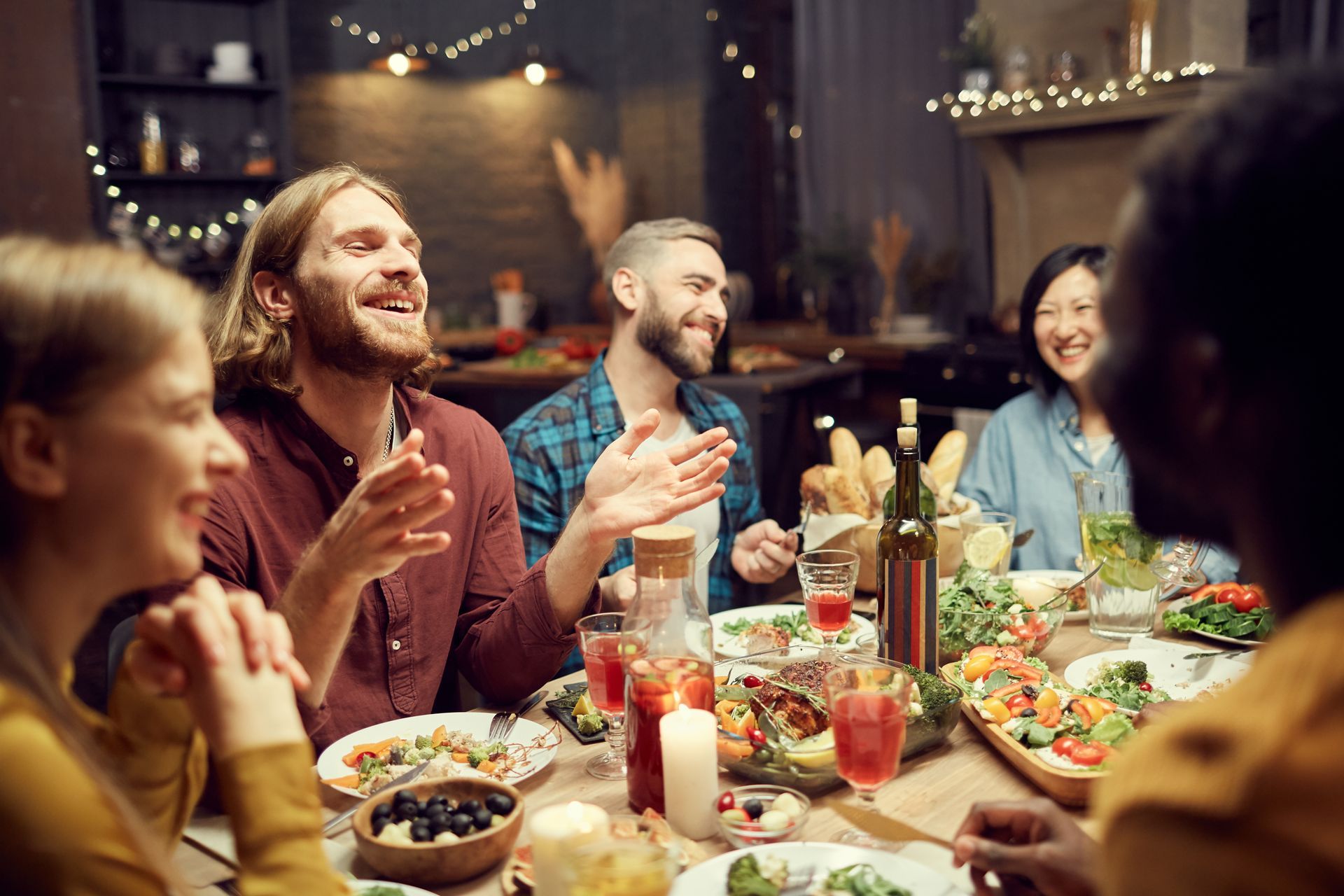 A group of people are sitting at a table eating food.