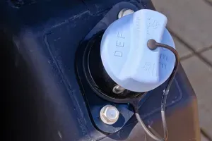 A light blue filler cap labeled 