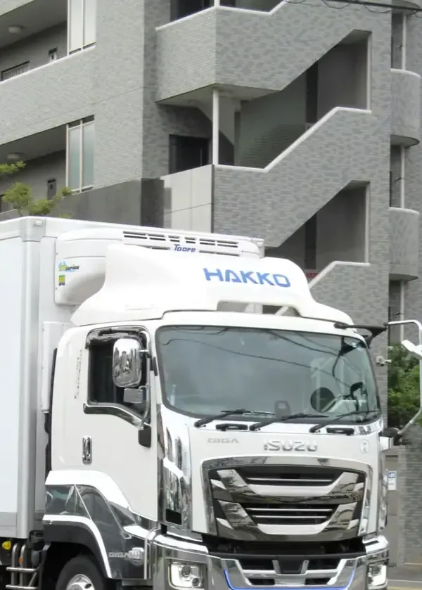 A white Isuzu delivery truck with 