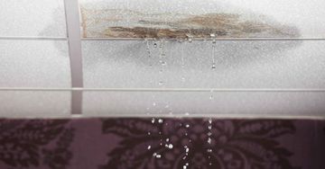 Water is dripping from the ceiling of a room.