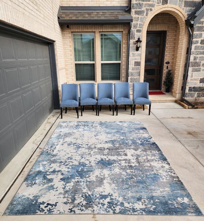 A row of chairs are lined up in front of a blue rug