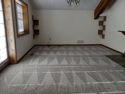 An empty room with a geometric pattern on the floor