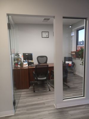 A small office with a desk , chair and computer.
