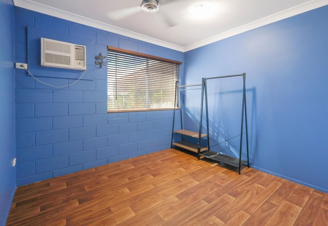 A Room With Blue Walls and Wooden Floors Has a Window and a Ceiling Fan — Outback Auctions and Real Estate in Karumba, QLD