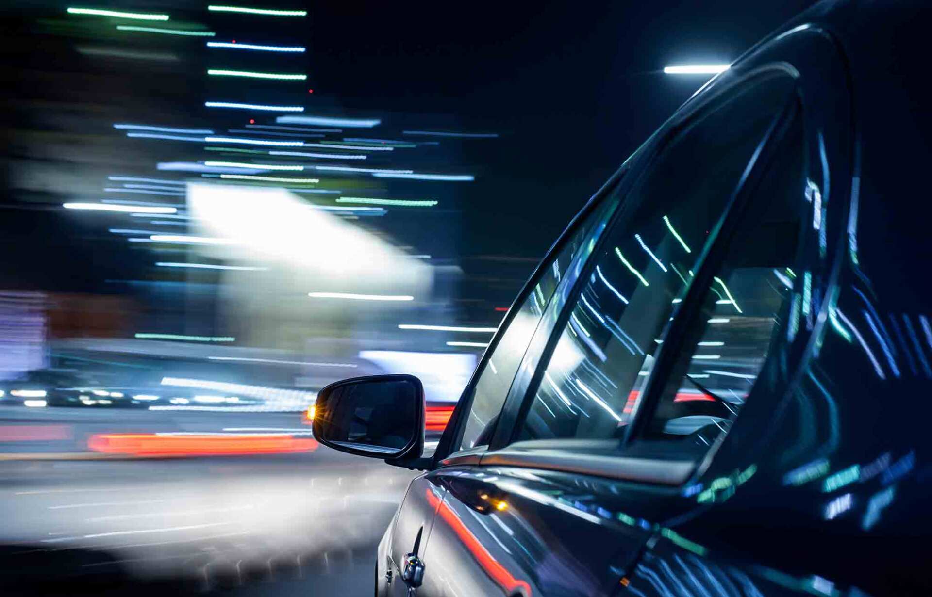 Streaking reflections in the car's surface and streaking background.