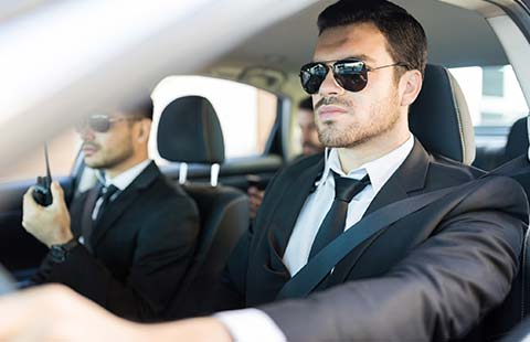Two Security Guards on a Car | Baltimore, MD | Arrington Security Investigations