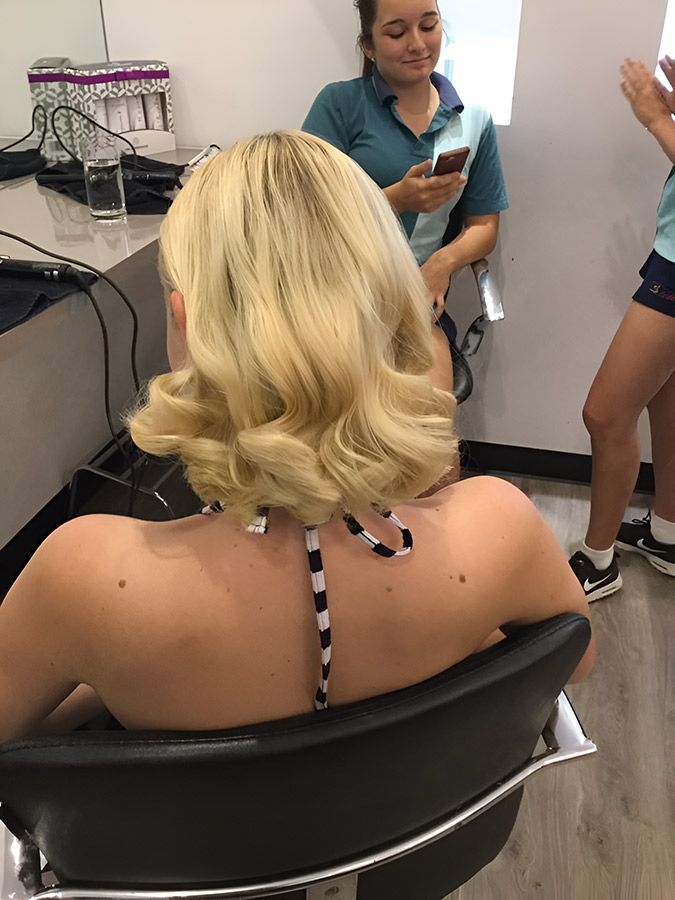 A Woman is Sitting in a Chair at a Hair Salon — Artistry of Hair in Redlynch, QLD