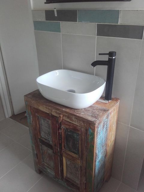a stunning bathroom sink with cabinet and holders installed