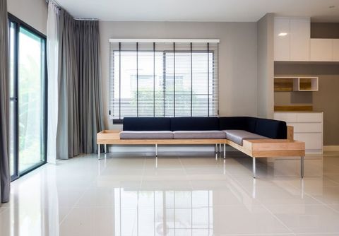 plain white tiling with L shaped sofa