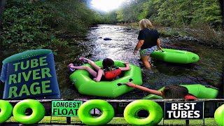 A group of people are floating down a river in green tubes.