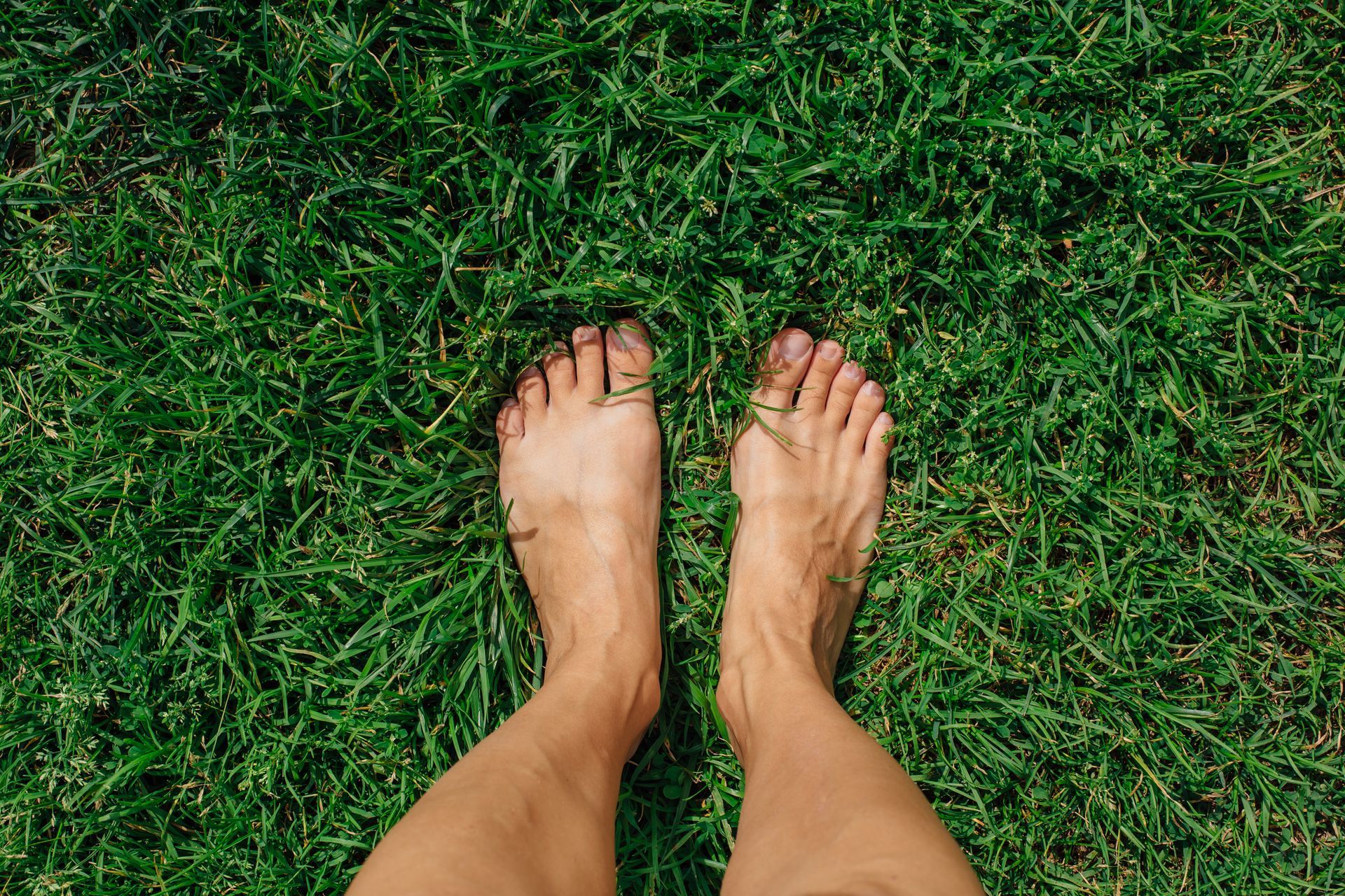 feet standing in spring grass