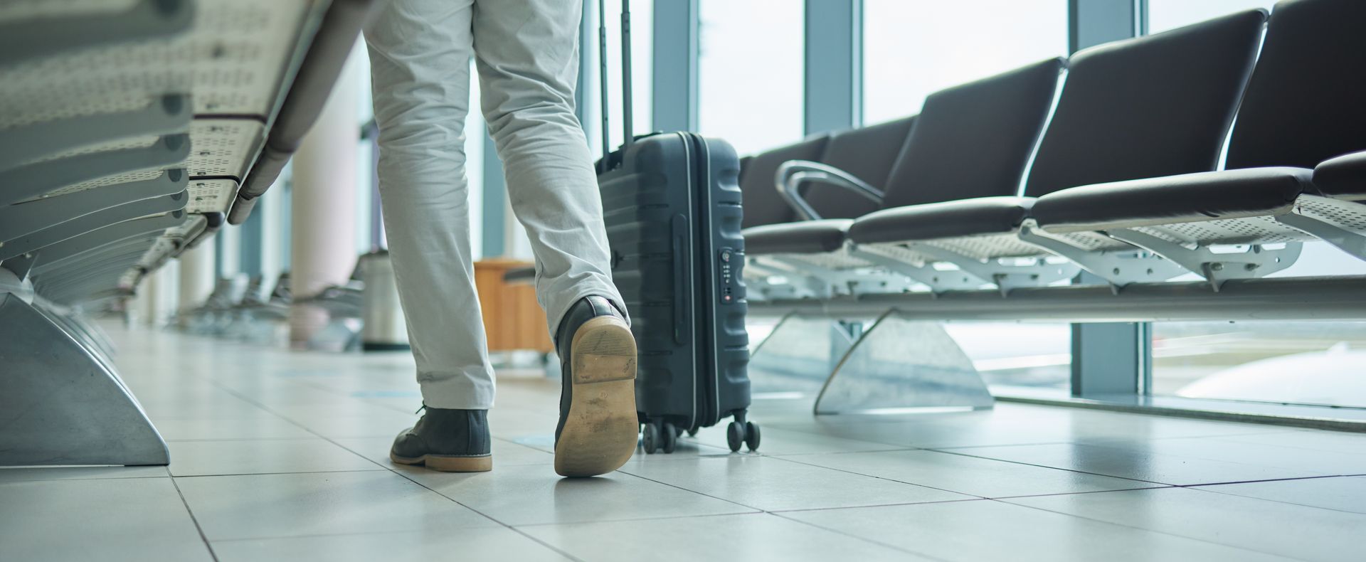 person walking with suitcase