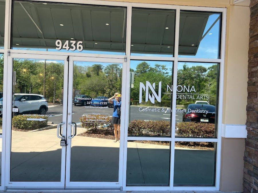 Exterior of a dental office with reflective windows. Building number