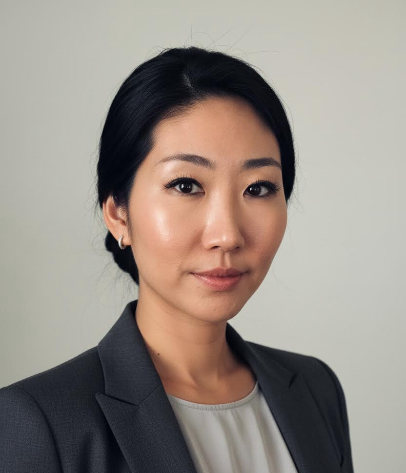 A woman with curly hair is smiling for the camera