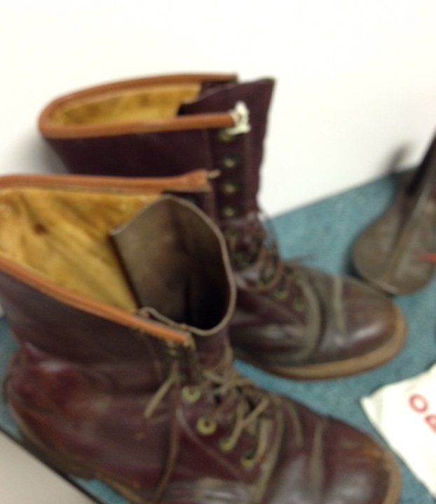 A pair of boots made in the institution shoe shop. They are tall lace-up work boots made from brown leather. Milton Parson, who ran away from the Ontario Hospital School, Orillia and drowned in 1937, was identified by his institution boots.