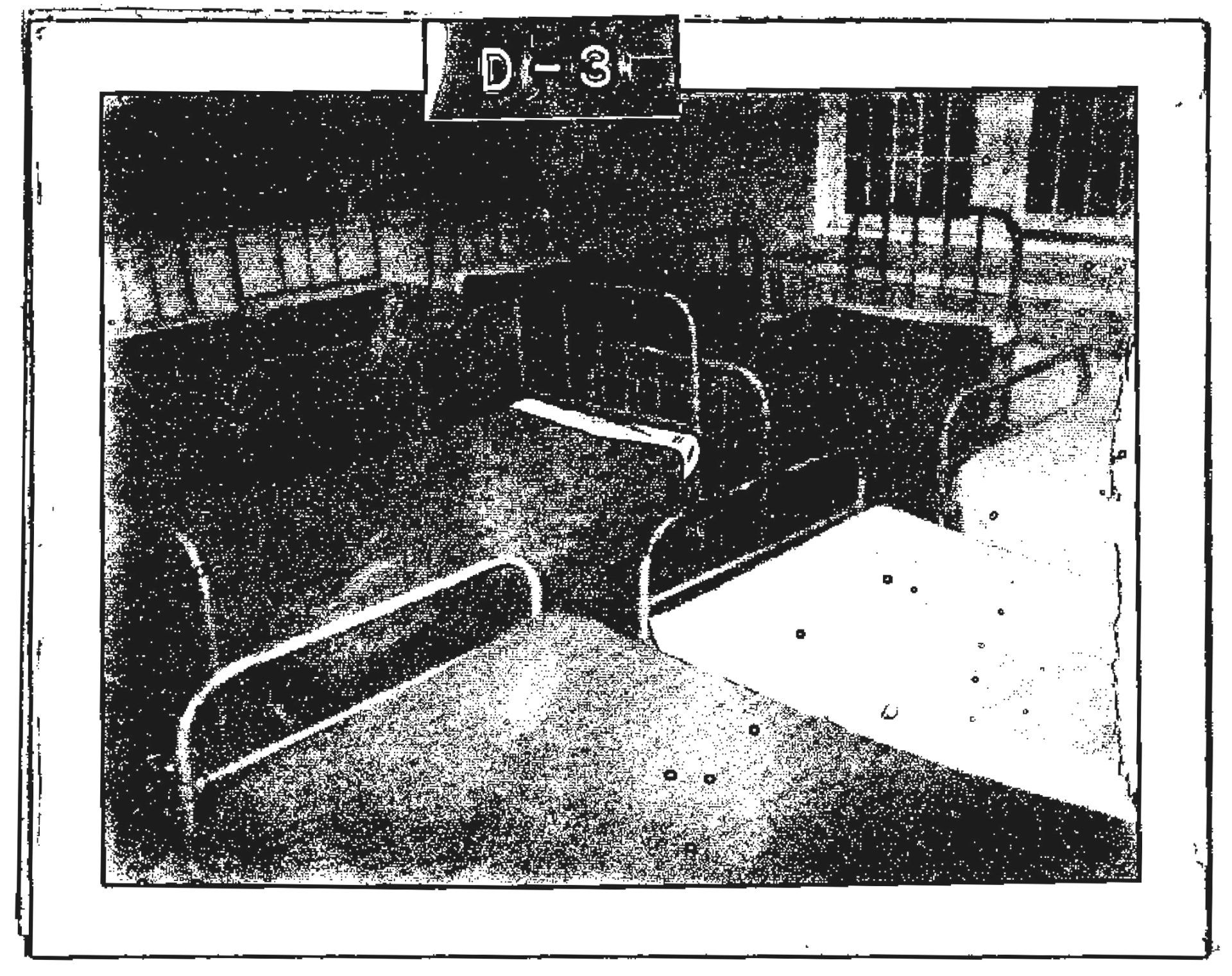 A ward on the third floor of Cottage D. Eight beds are visible, separated by only inches. In the background is a barred window. Image from the Regional Centre Records