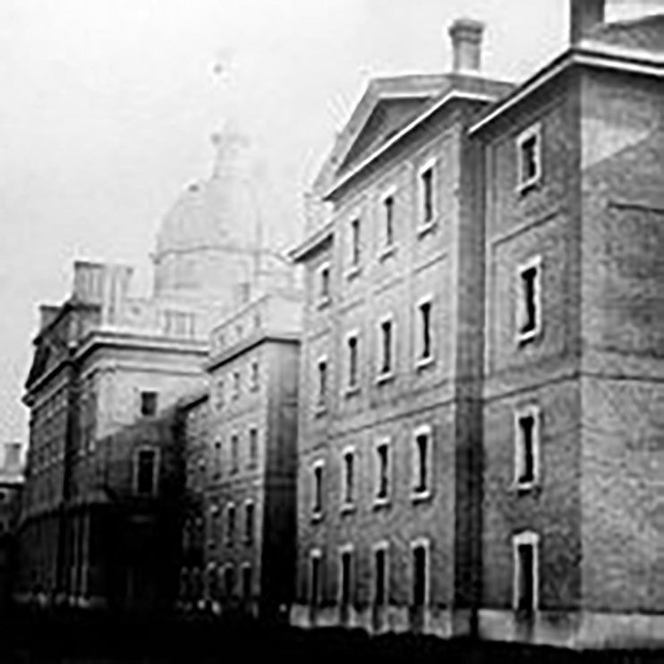 A photograph of the Provincial Asylum at 999 Queen Street West, taken in 1867. The image shows a large four storey building with two wings and a cental ornate dome. The institution that became the Huronia Regional Centre began as a branch of the Provincial Asylum.